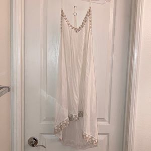 White dress with brown stitching